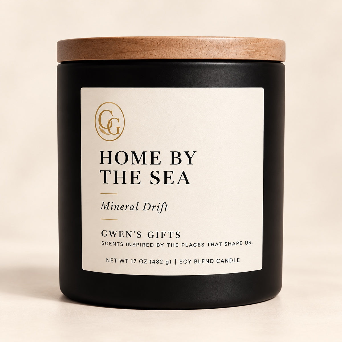 Home by the Sea candle, Mineral Drift, in a matte black vessel with a natural wood lid